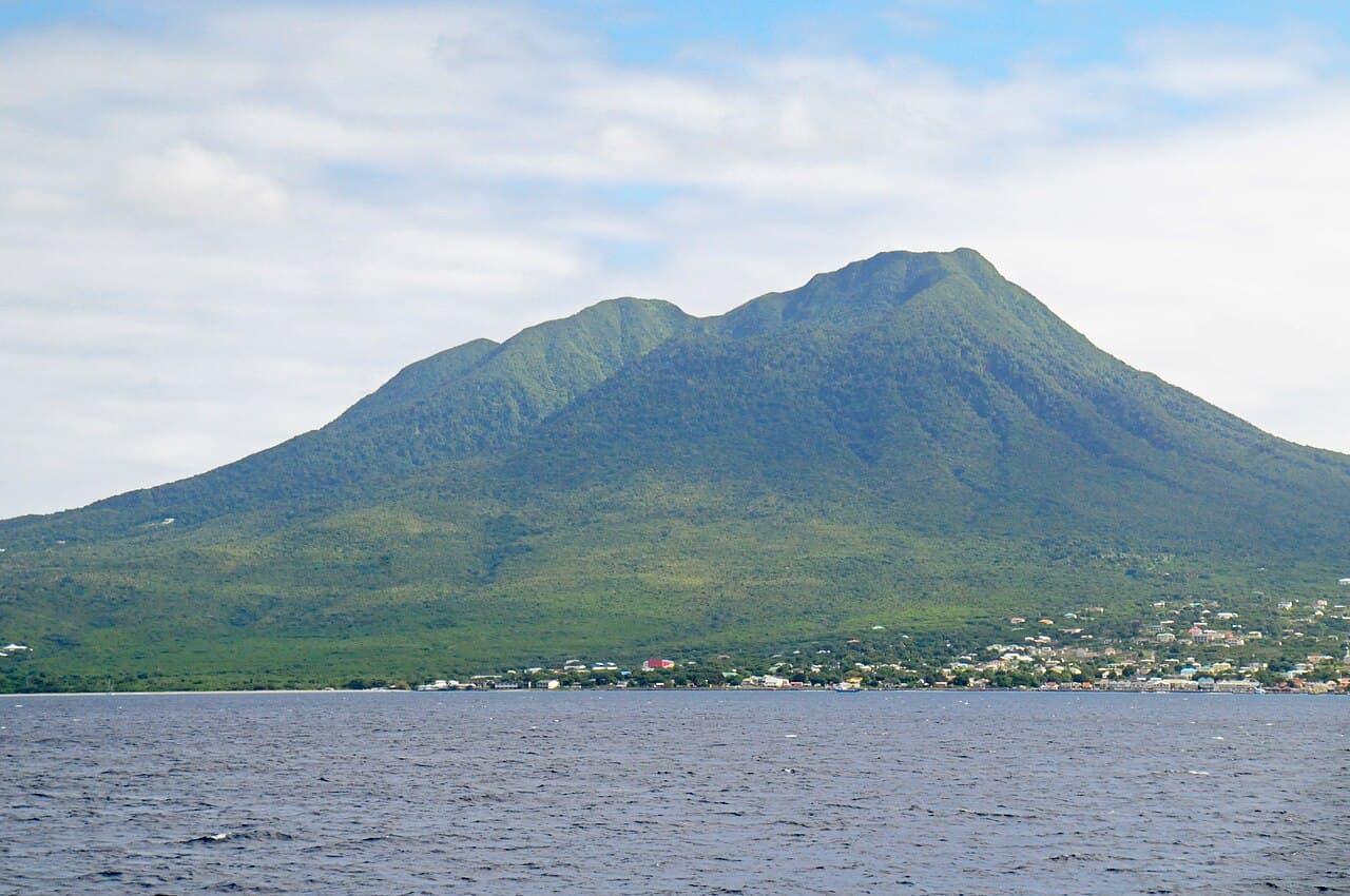 Vulkantoppen Nevis Peak med skyer rundt